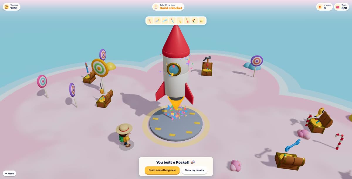 A finished red and white rocket on its launch pad with confetti and engine flame